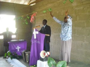 Pastor George preaches at one of the churches we built for the people.